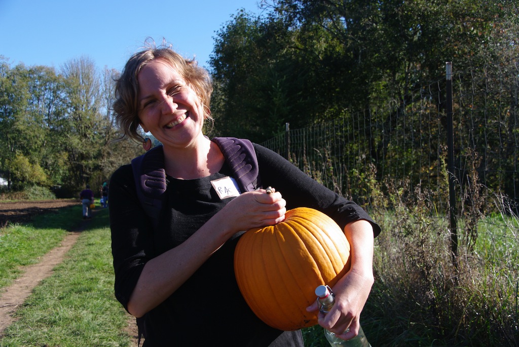 A happy CSA member with her pumpkin